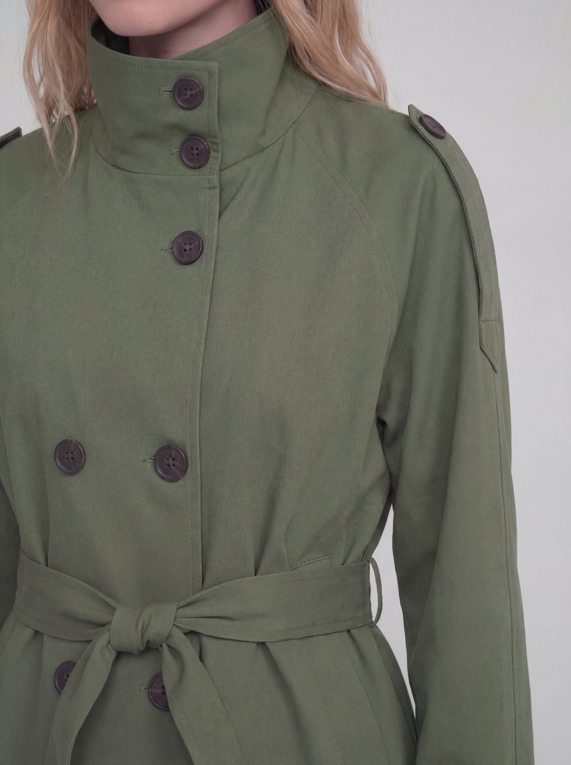 Green coat with buttons on a white background